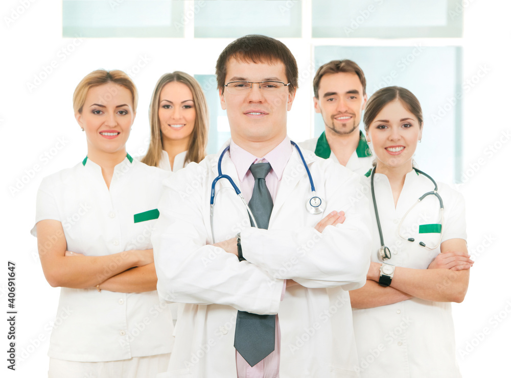 A team of young and smart Caucasian doctors in white A team of young and smart Caucasian doctors in white