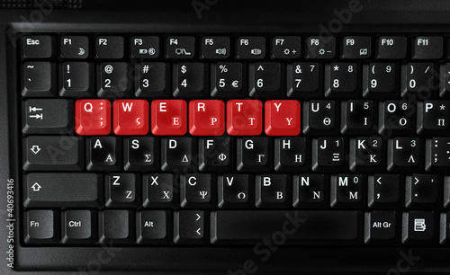 Computer laptop  keyboard showing qwerty letters colored in red