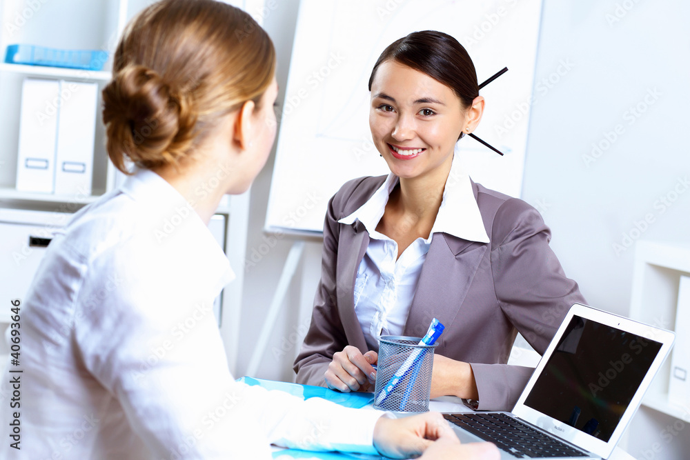 Young women in business wear working in office Young women in business wear working in office