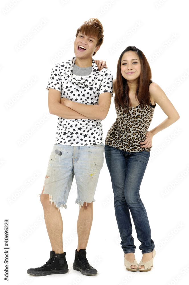 Playful young couple standing on white background Playful young couple standing on white background