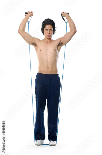 Young man training his body with rubber for trainin