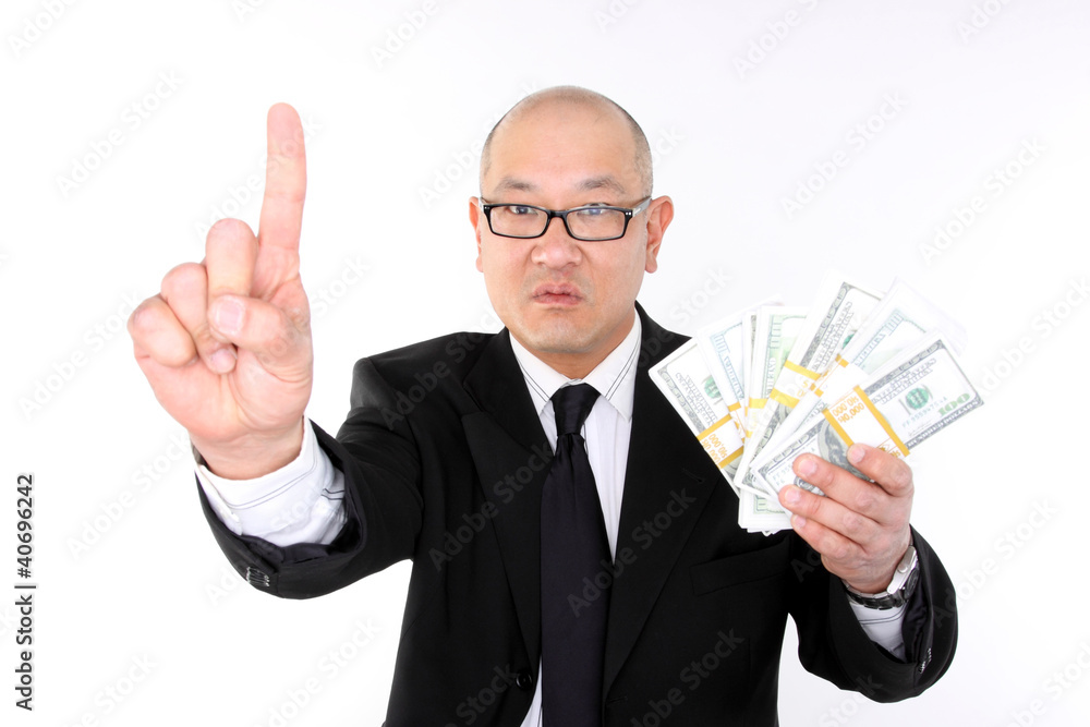 Asian man in a suit with bundles of cash. Asian man in a suit with bundles of cash.