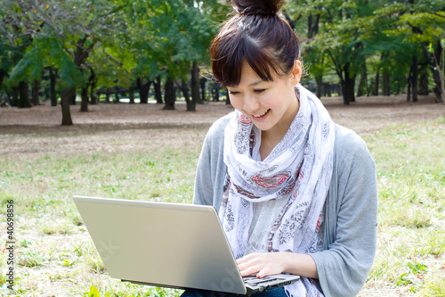 Beautiful asian woman using a laptop computer