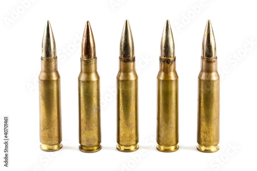 Row of five rifle bullets