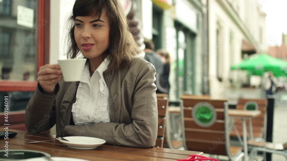 Young happy woman drinking coffee in the city, steadicam shot Young happy woman drinking coffee in the city, steadicam shot