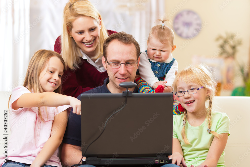 Family with computer having video conference Family with computer having video conference