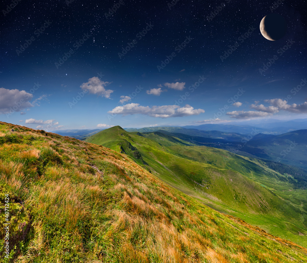 Summer landscape in the mountains with stars and moon in the sky