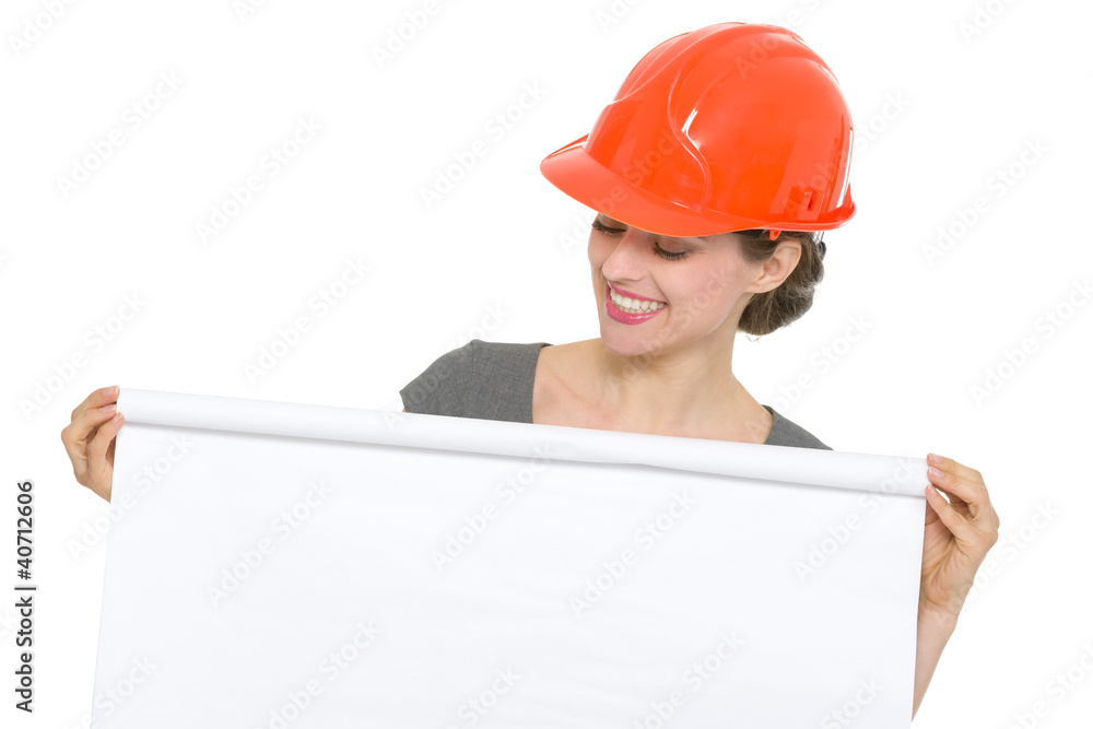 Smiling architect woman looking on blank flip chart isolated Smiling architect woman looking on blank flip chart isolated
