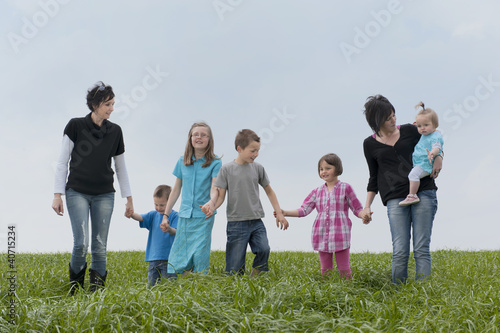 family walking in the meadow