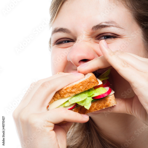 Hungry woman eating sandwich