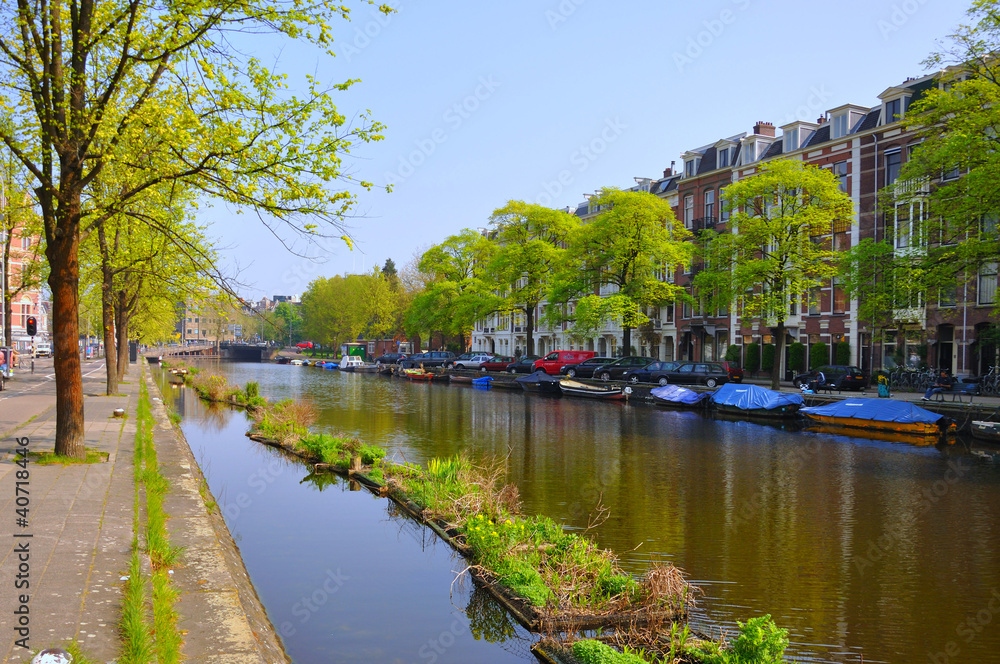 Beautiful river with boats in Amsterdam, Holland (Netherlands)