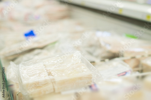 Frozen fish in packs in supermarket