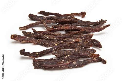 South African biltong strips  isolated on a white background photo