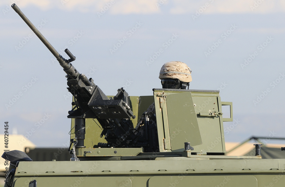 soldiers in armored vehicle ready to fire
