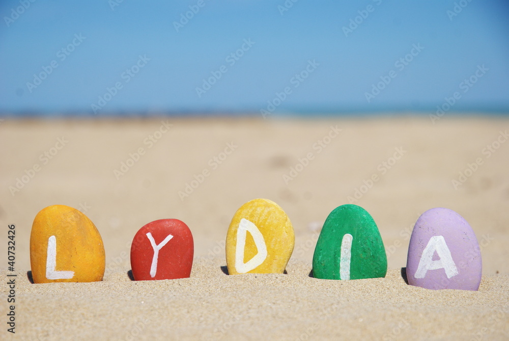 Obraz premium Lydia, female name on colourful pebbles