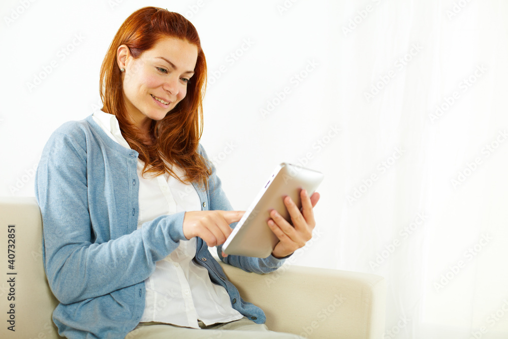 Elegant young woman using a tablet PC Elegant young woman using a tablet PC