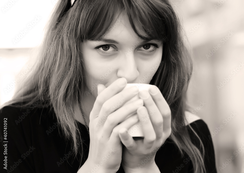 young girl with a cup of coffee. Focus on the eyes. young girl with a cup of coffee. Focus on the eyes.