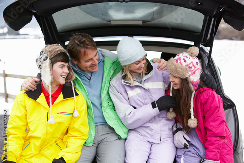 Teenage Family Sitting In Boot Of Car Wearing Winter Clothes © Monkey Business