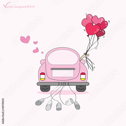 Just married on car driving to their honeymoon