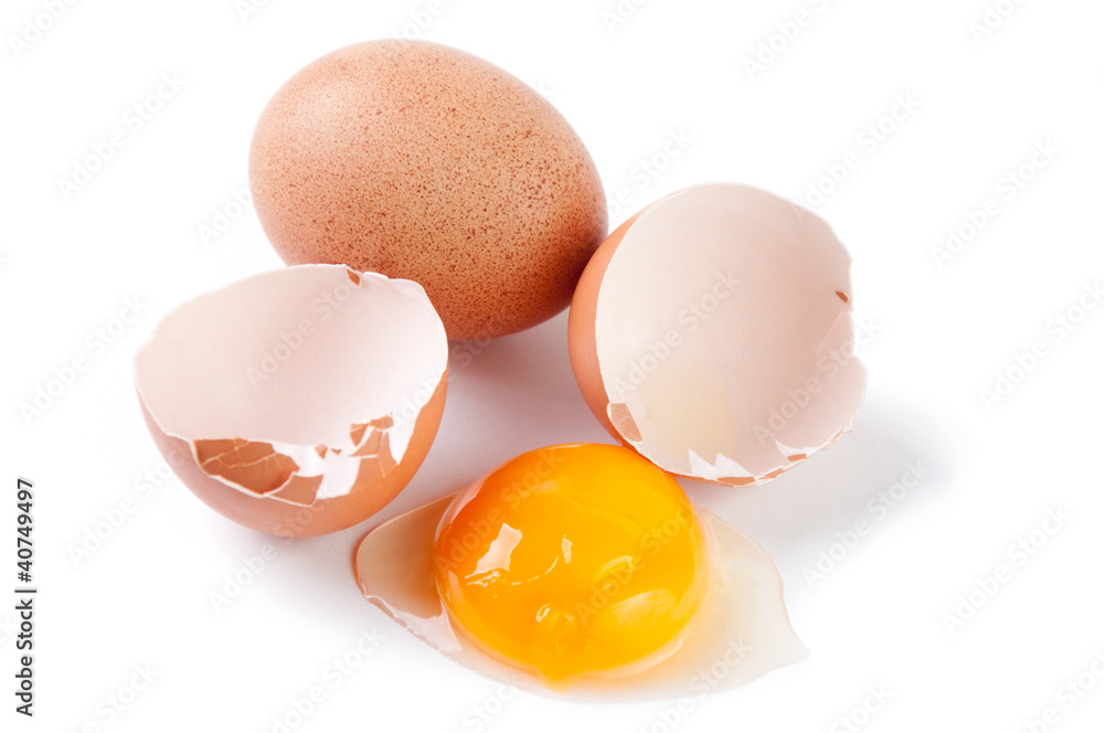 Broken egg and yolk, white background Broken egg and yolk, white background