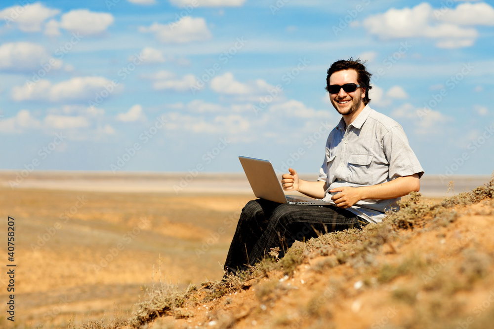 happy man with laptop outdoors