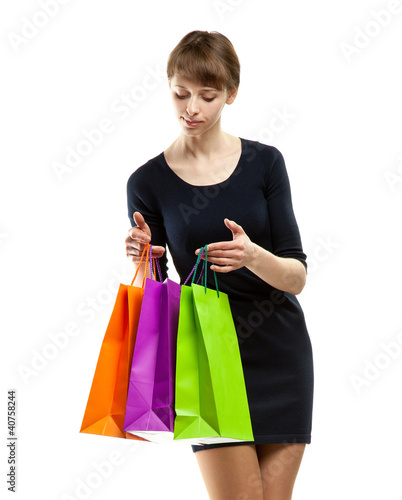 Attractive young woman looking into paper bags