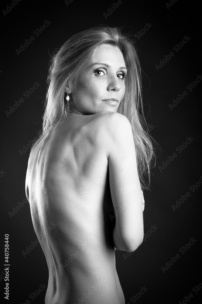 Black and white woman portrait against black background. Black and white woman portrait against black background.