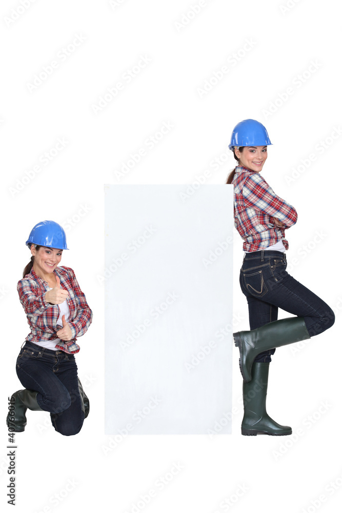 girls wearing blue hard hat striking a pose girls wearing blue hard hat striking a pose
