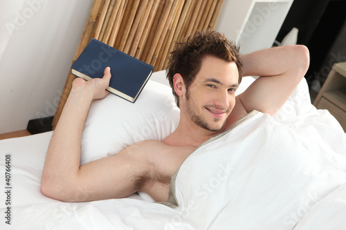 man relaxing in his bed