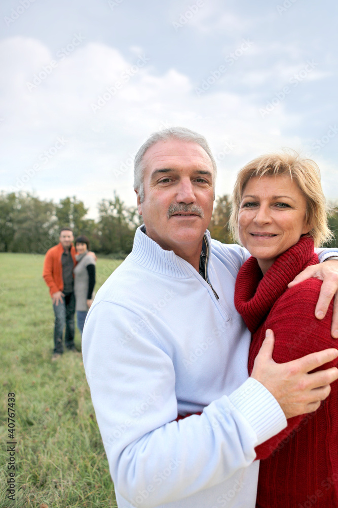 Obraz premium Two generations stood in field