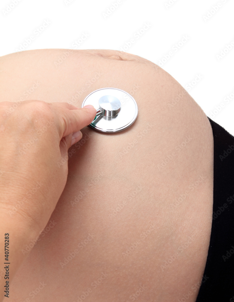 Fototapeta premium Pregnant woman being examine by a doctor with a stethoscope