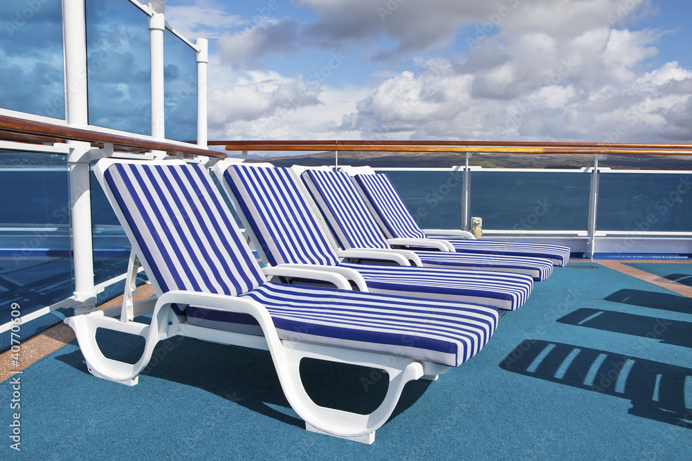 Fototapeta premium Roe of deck chairs on sundeck of the cruise ship