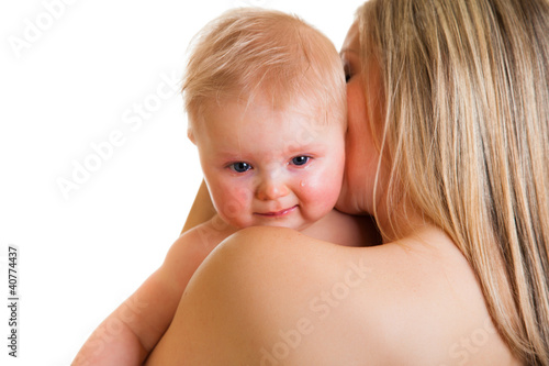 Mother conforting crying infant girl isolated on white photo