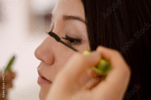 Hairstylist putting makeup on a client