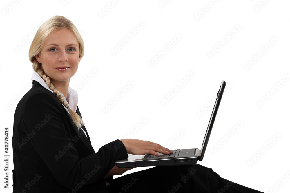 Profile view of blond office worker with laptop Profile view of blond office worker with laptop