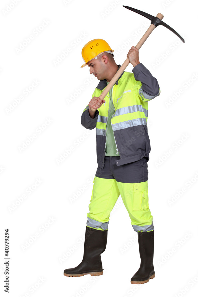 Laborer using pickaxe on white background Laborer using pickaxe on white background