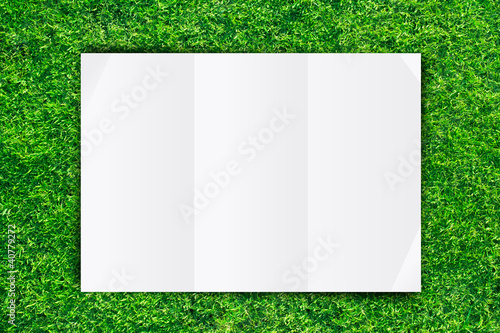 White Crumpled paper on Grass background