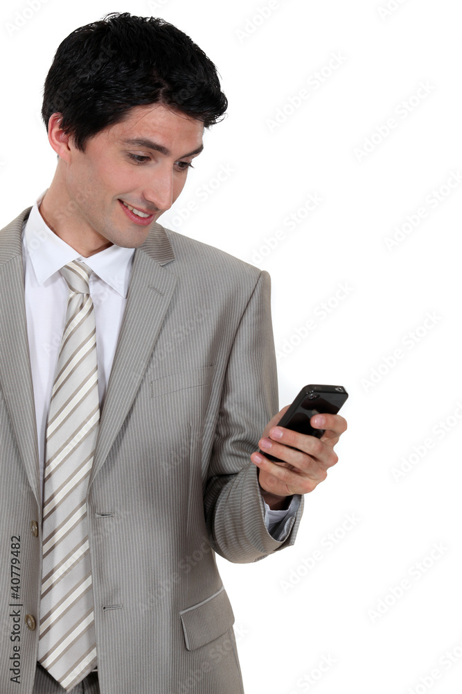Businessman excited by text message in mobile Businessman excited by text message in mobile