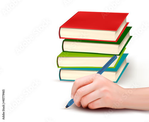 Hand with pen writing on paper and stack of book