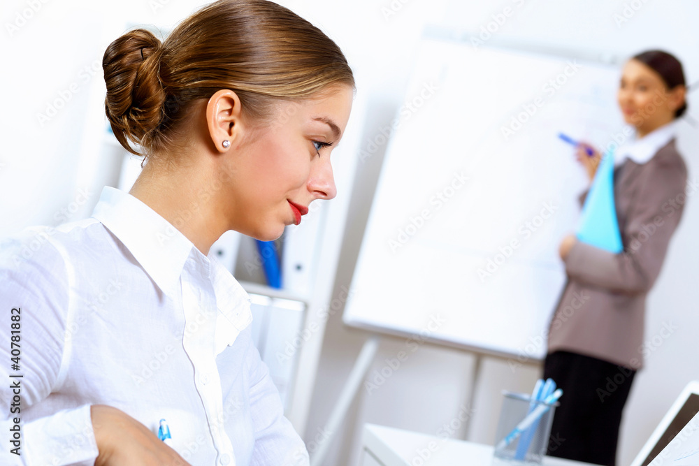 Young women in business wear working in office Young women in business wear working in office