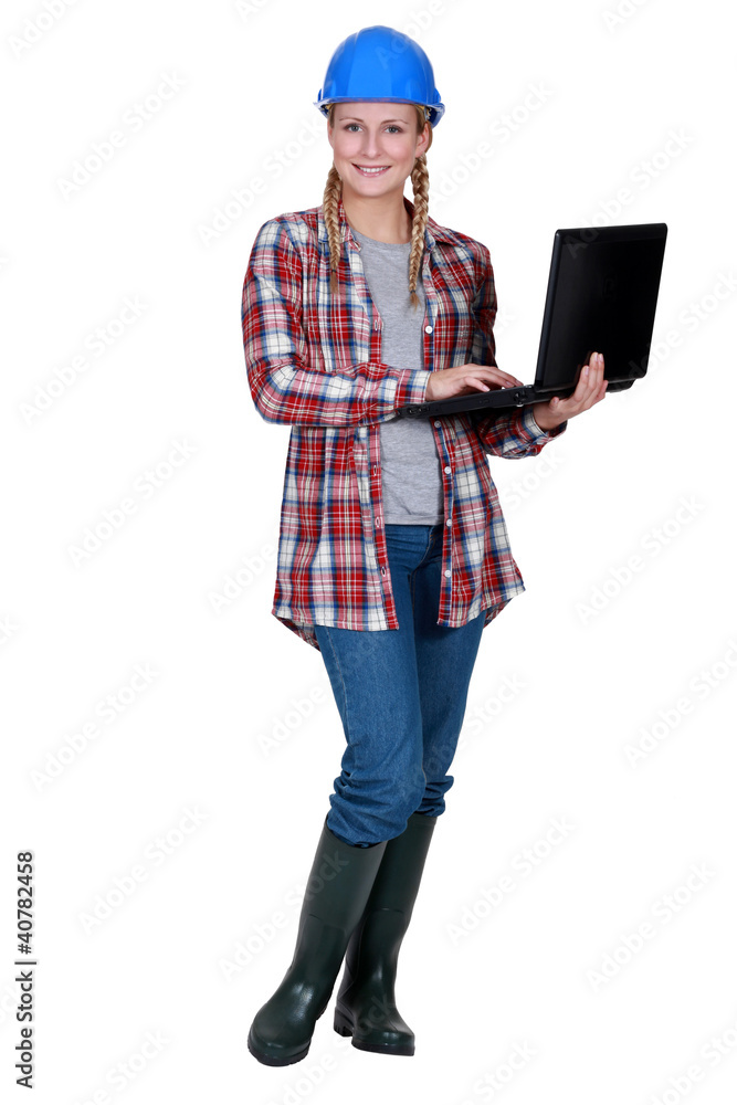 A female foreman with a laptop. A female foreman with a laptop.