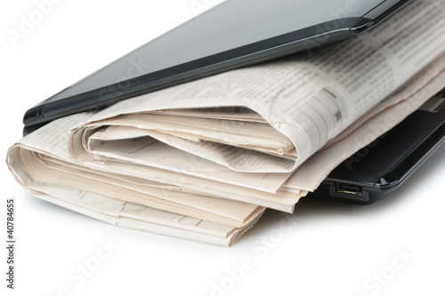 Newspaper and a laptop