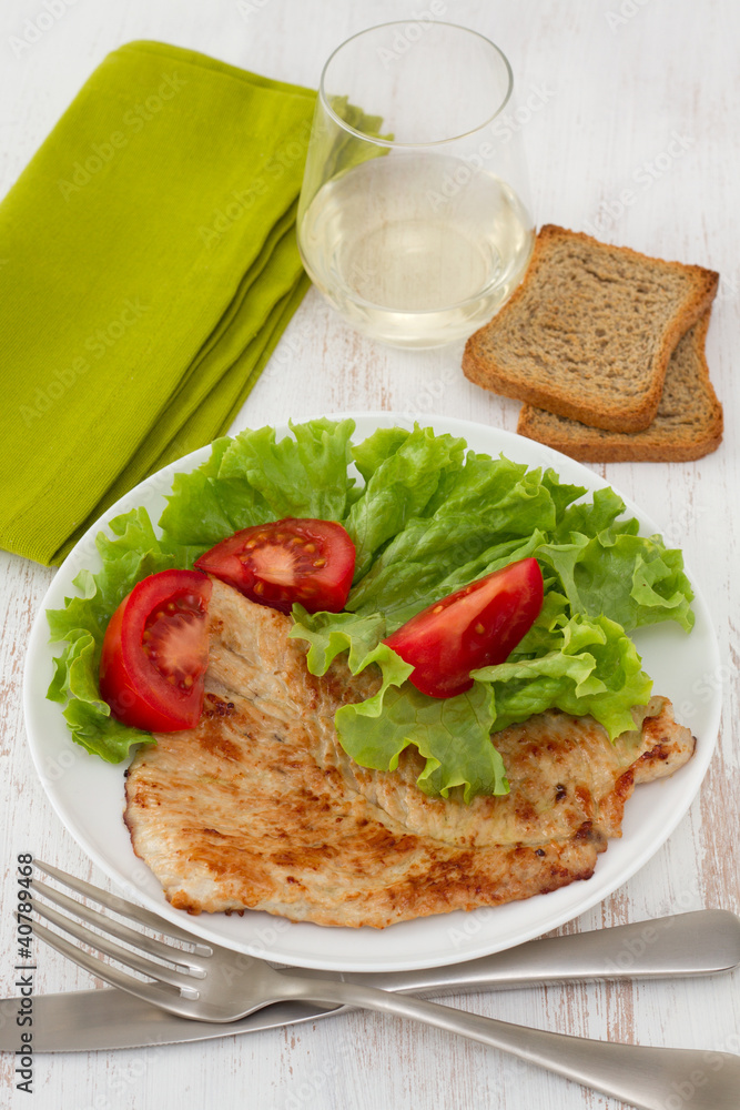 fried turkey with salad on the white plate fried turkey with salad on the white plate