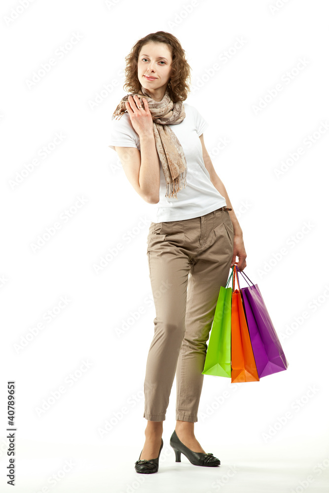 Happy beautiful young woman holding multicolored paper bags Happy beautiful young woman holding multicolored paper bags