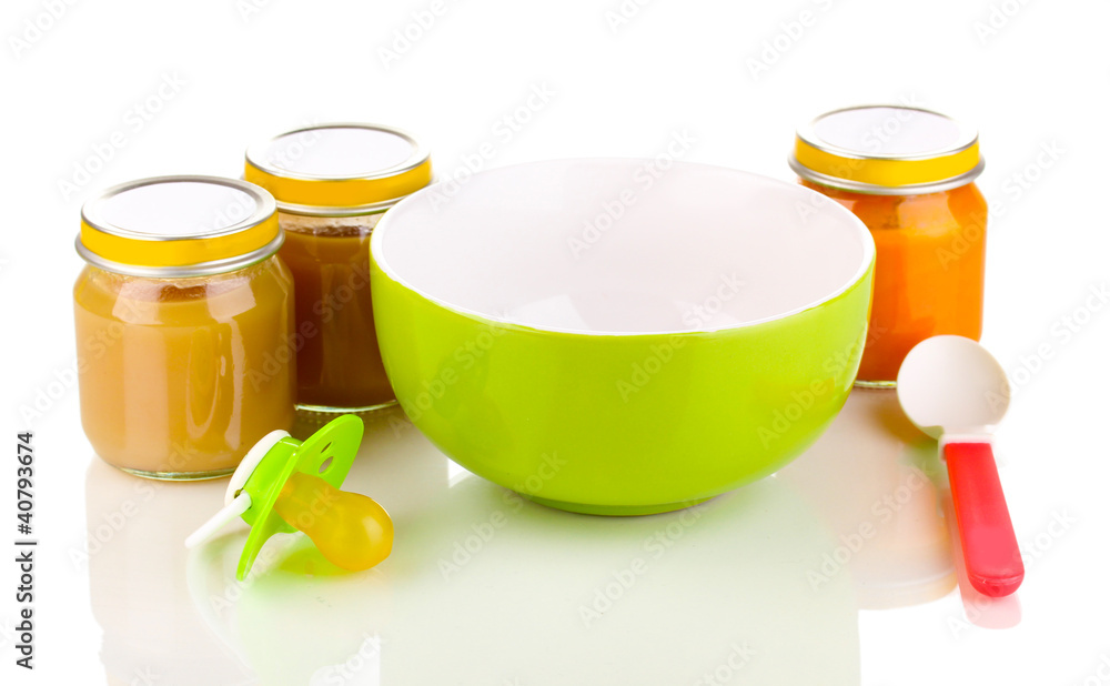 Jars of baby puree with plate and spoon isolated on white Jars of baby puree with plate and spoon isolated on white