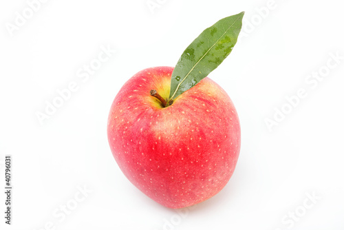 Healthy food. Fresh red apple with green leaf on a white backgro