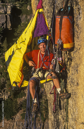 Rock climber in his shelter. photo
