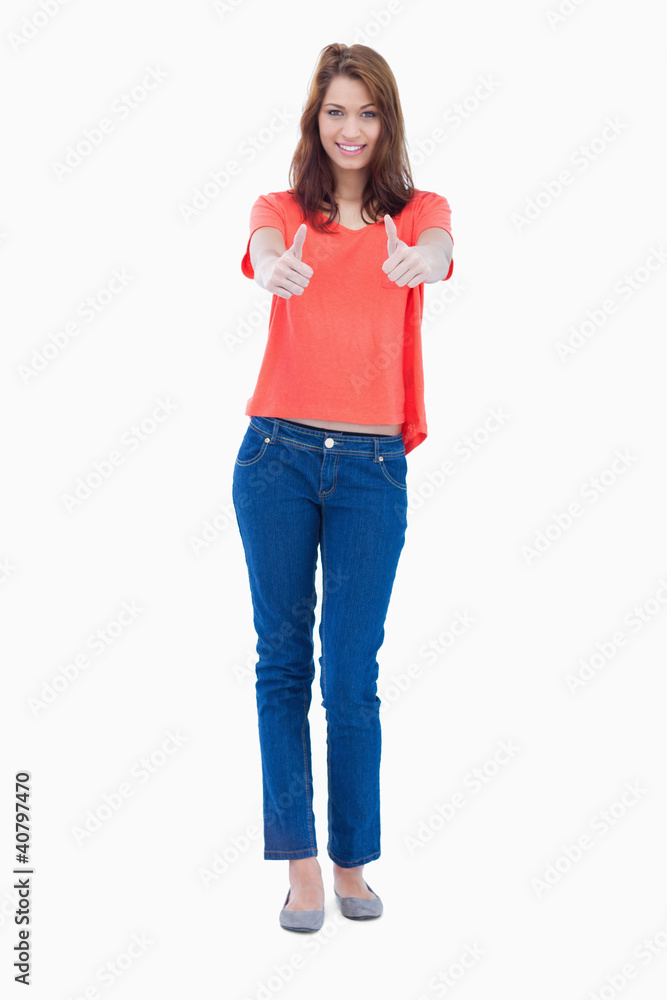 Teenager putting her thumbs up in front of her Teenager putting her thumbs up in front of her