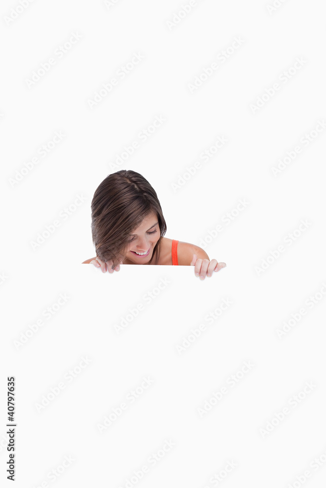 Teenage girl leaning her head forward while looking at a blank p Teenage girl leaning her head forward while looking at a blank p