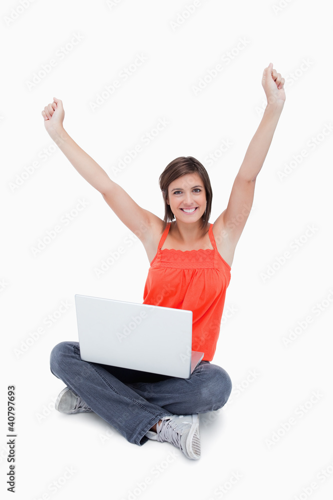 Attractive young woman sitting cross-legged and raised arms Attractive young woman sitting cross-legged and raised arms